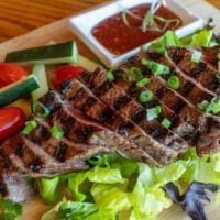 Crying Tiger (Flank Steak) · Gluten-free. Grilled marinated beef steak served with tamarind chili dipping sauce