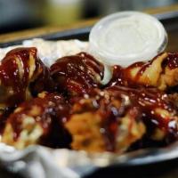Wings · Available in Hot, BBQ, or Plain. Served with a side of ranch or blue cheese dressing