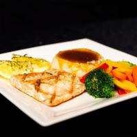 Grilled Alaskan Salmon · Grilled Alaskan Salmon served with sautéed vegetables and choice of potato.