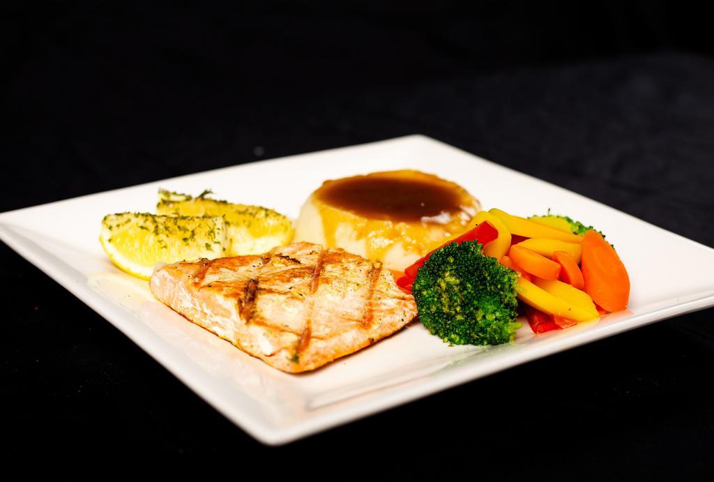 Grilled Alaskan Salmon · Grilled Alaskan Salmon served with sautéed vegetables and choice of potato.