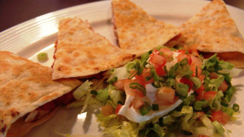 Quesadilla · Salsa and cheese folded in a flour tortilla along with grilled chicken Served with sour cream.