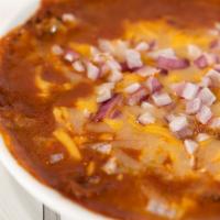 Chili · Chili topped with cheese and onions served with chips.