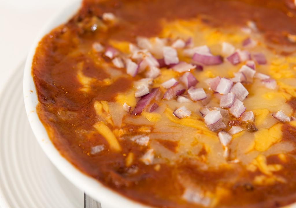 Chili · Chili topped with cheese and onions served with chips.