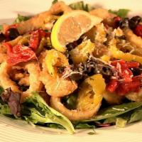 Calamari Mediterranean · Our crispy calamari served over garden greens and topped with red roasted peppers, sliced bl...