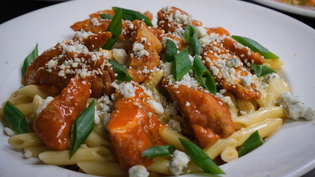 Buffalo Mac 'N Cheese · Penne pasta mixed with a rich cheese sauce and topped with buffalo chicken bites, bleu cheese crumbles, and sliced scallions.