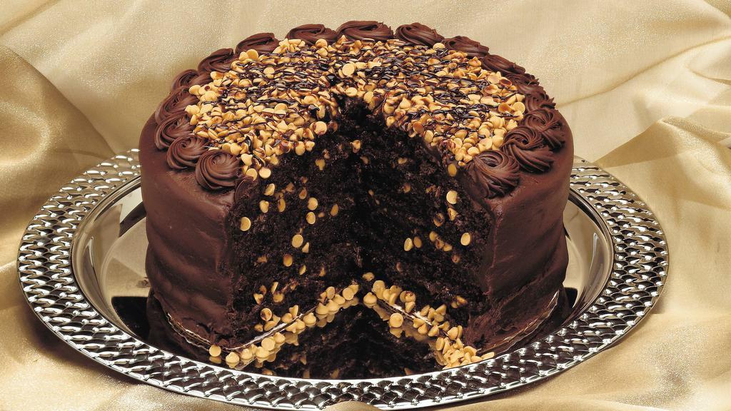 Wh Peanut Butter Choc Cake · Four layers of chocolate cake filled with peanut butter, frosted with chocolate frosting and topped with peanut butter chips.