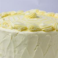 Slice Of Lemon Burst Cake · Four layers of white cake filled with lemon filling and finished with our lemon butter cream...