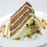 Slice Of Carrot Cake · Four layers of our carrot cake filled with our cream cheese frosting.
