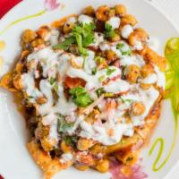 Samosa Chat · consists of a crushed crunchy potato stuffed samosa that is then topped with channa/chickpea...