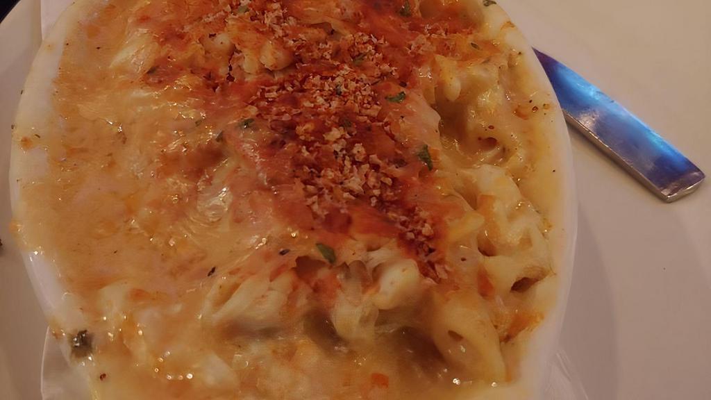 Crab Mac & Cheese · Penne blended in a creamy four cheese blend then topped with lump crab.