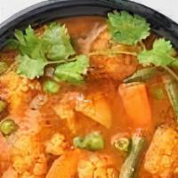 Vegetable Curry · Vegetarian. Mixed vegetable cooked in curry sauce with fresh herbs and spices.
