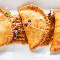 Empanadas · Grass-fed skirt steak, signature ranchero sauce.