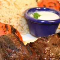 Beef Kabob · Grilled pieces of filet mignon with tomatoes, onions, parsley and tahini sauce.