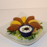 Kibbeh Balls 4 Pieces · Ground beef and wheat cracker stuffed with minced meat, onions and pine nuts.