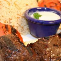 Beef Kabob · Marinated filet mignon pieces grilled to perfection, served with rice and grilled vegetables.