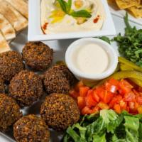 Falafel Platter · Served with small hummus, tomatoes, lettuce, pickles, fresh mint, tahini sauce, and soft pit...