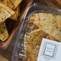 Pita Chips · Made fresh and in house crispy pita chips with oil and zataar on the side