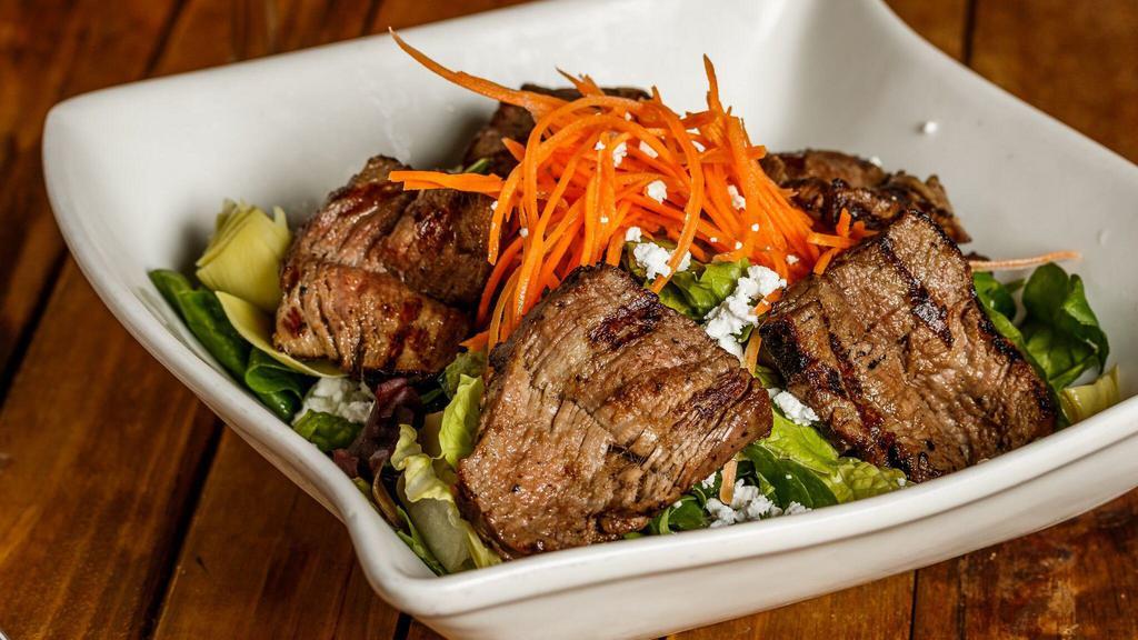 Beef Tenderloin Salad · Mixed greens, carrots, sun-dried tomatoes, artichoke, red onion, roasted corn toasted, black olives, and feta cheese in a roasted garlic dressing.