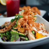 Sesame Chicken Salad · Mixed greens and mandarin oranges tossed in a sweet sesame dressing topped with wonton strip...