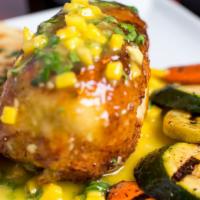 Mango Stuffed Chicken · Panko crusted stuffed breast topped with mango butter sauce, served with creamy scalloped po...