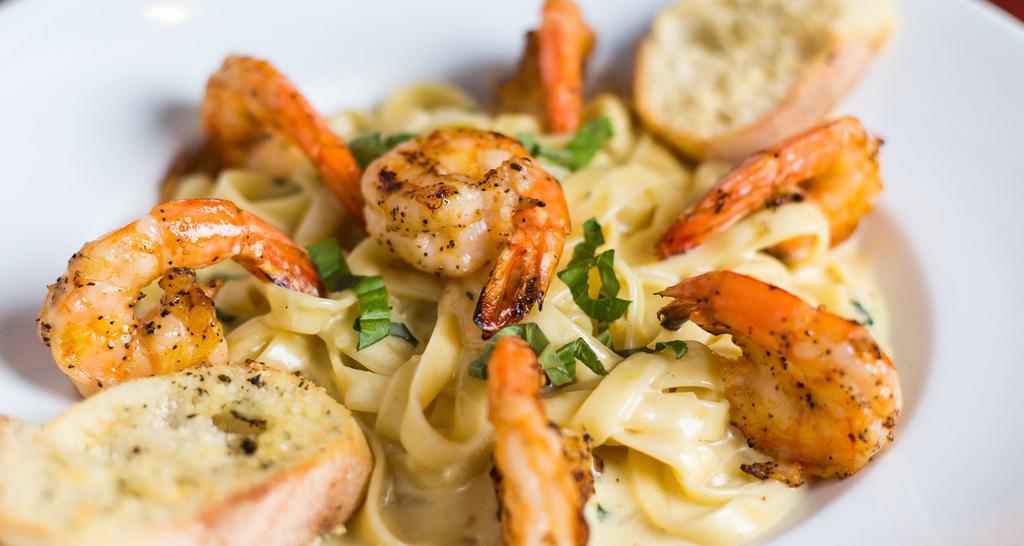 Grilled Shrimp Pasta · Fettuccini pasta in creamy alfredo sauce.