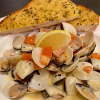Steamed Clams · Manila clams simmered in a white wine reduction with lemon, garlic, fresh herbs, diced tomat...