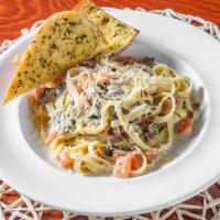 Carbonara · Fettuccine, bacon, mushrooms, green onions, diced tomatoes, alfredo sauce, and Parmesan chee...