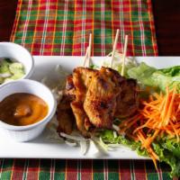 Chicken Satay · Grilled chicken tenders marinated on skewers served with delicious peanut sauce and Thai Sty...