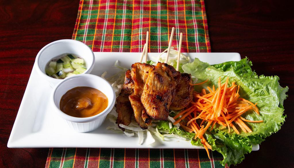 Chicken Satay · Grilled chicken tenders marinated on skewers served with delicious peanut sauce and Thai Style Sweet Cucumber Relish (Arjard Sauce).
