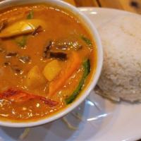 Panang Curry · Peanut based curry mixed with coconut milk and garnished with bell peppers.