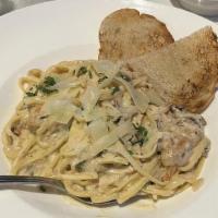 Chicken Scallopini · Chicken breast cooked with white wine, and lemon caper sauce. Served over a bed of linguine ...