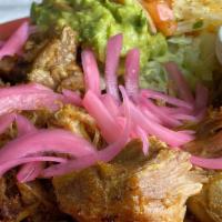 Pork Carnitas · Braised pork served with guacamole, queso fresco, lettuce, cheese mix, pico de gallo, flour ...