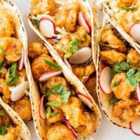 Shrimp Tacos · Two pieces. Shrimp tacos on corn tortillas, lettuce, corn, pico de gallo, and cilantro lime ...