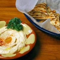 Hummus · Chickpeas purreed with tahini, fresh lemon juice and garlic. Topped with EVOO.