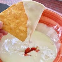 Queso · CUSTOMER FAVORITE! House made queso served with tortilla chips.