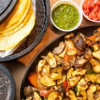Vegan Fajitas · mushrooms and zucchini served over peppers & onions with guacamole,.  salsa verde, pico, bla...