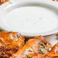 Buffalo Style Chicken Wings · 8 meaty wings served with celery, carrots & your choice of ranch or bleu cheese dressing.