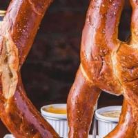 Jumbo Soft Pretzel (V) · Warm salted pretzel served with Guinness mustard and house queso.