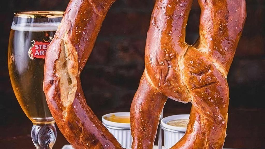 Jumbo Soft Pretzel (V) · Warm salted pretzel served with Guinness mustard and house queso.