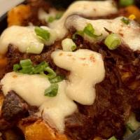 Short Rib Poutine · Goose's seasoned fries smothered in a rich, savory short rib ragu and curds of white cheddar...