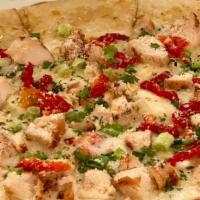 Artichoke Dip Pizza · Our famous Artichoke Dip topped with diced grilled chicken, sun-dried tomatoes, chopped scal...