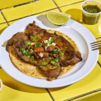 Carne Asada. · Sonoran-style carne asada. Thinly sliced sirloin, topped with cilantro, onion and avocado-to...