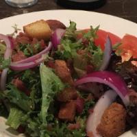 Hand Tossed Chop House Salad · Mixed field greens, tomatoes, red onions, bacon crumbles, and garlic croutons.
