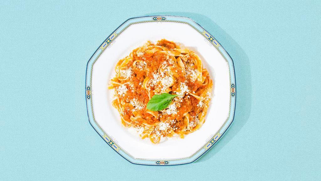 Fettuccine Bolognese · Fettuccine in a traditional Bolognese sauce topped with fresh Parmesan cheese.
