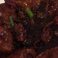 Orange Chicken · Deep-fried chicken chunks in chef's special rich brown sauce with red peppers and orange pee...