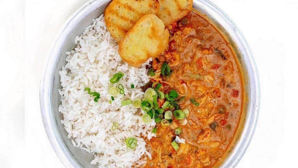 Crawfish Etouffee · Rich creamy crawfish stew served alongside steamed white rice