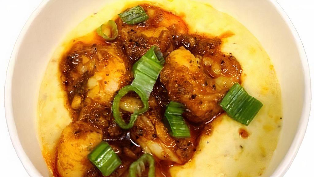 Shrimp And Grits · Creamy yellow grits topped with shrimp and trinity sauce