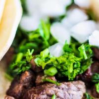 Carne Asada Taco · Corn tortilla, carne asada, lettuce, tomato, onion, cilantro, and cheese. Served with a side...