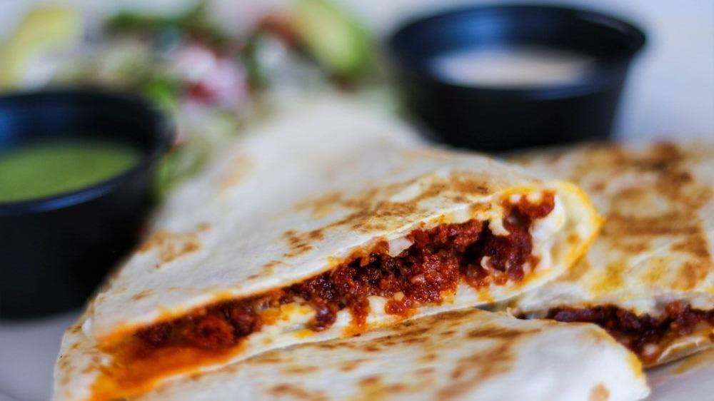 Quesadilla With Al Pastor · Cheesy heaven. Flour tortilla, al pastor adobo pork, and mixed cheese. Served with a side of homemade salsa, authentic mexican crema, and pico de gallo. Add guacamole for an additional charge.
