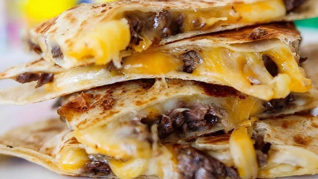 Quesadilla With Carne Asada · Cheesy heaven. Flour tortilla, carne asada, and mixed cheese. Served with a side of homemade salsa, authentic Mexican crema, and pico de gallo. Add guacamole for an additional charge.